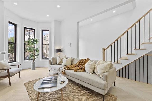 living room with a wealth of natural light and light parquet flooring