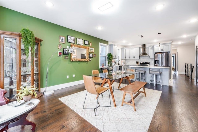 dining space with dark hardwood / wood-style floors