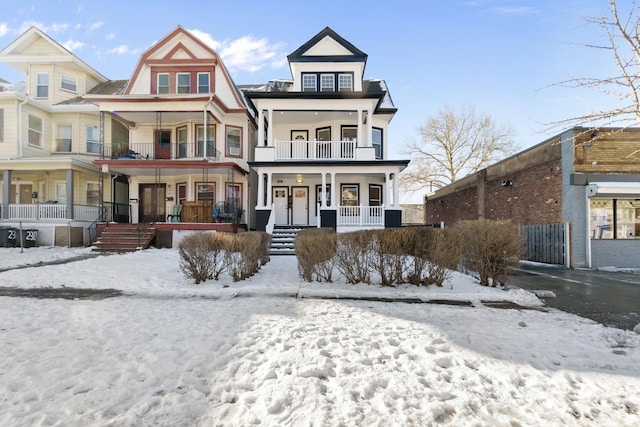 view of front of property featuring a balcony and covered porch