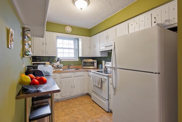 kitchen with light countertops, white cabinetry, a sink, white appliances, and under cabinet range hood