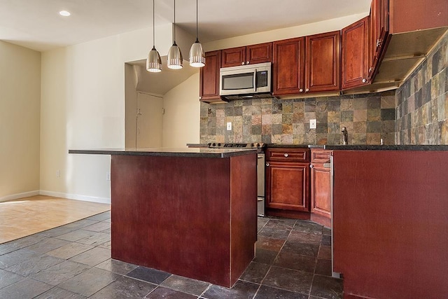33 W 24th St, Bayonne, NJ 07002 - kitchen featuring stainless steel appliances, stone tile flooring, dark countertops, dark brown cabinets, and recessed lighting