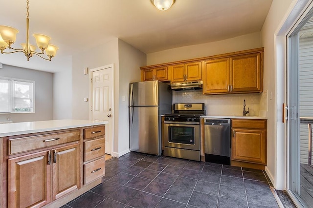 33 W 24th St, Bayonne, NJ 07002 - kitchen with appliances with stainless steel finishes, under cabinet range hood, tasteful backsplash, and light countertops
