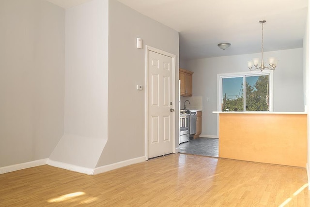 33 W 24th St, Bayonne, NJ 07002 - unfurnished dining area featuring light wood-type flooring, a chandelier, and baseboards