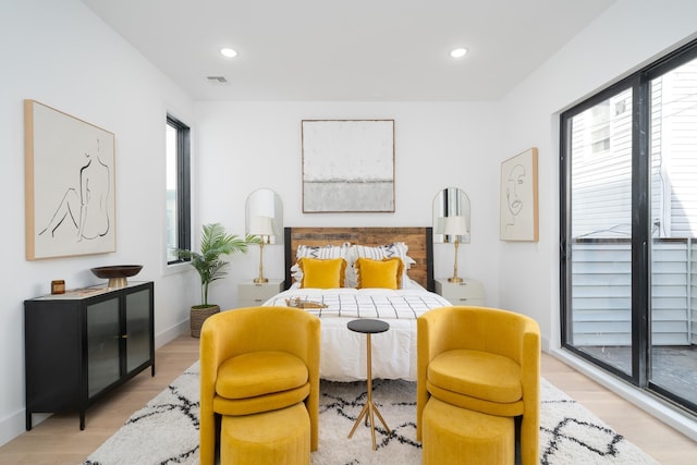 bedroom featuring recessed lighting, light wood-style floors, visible vents, and multiple windows