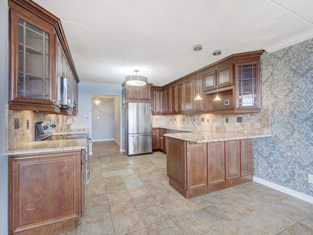 250 Gorge Rd Unit 16D, Cliffside Park, NJ 07010 - kitchen featuring stainless steel appliances, a peninsula, light stone counters, tasteful backsplash, and a textured ceiling