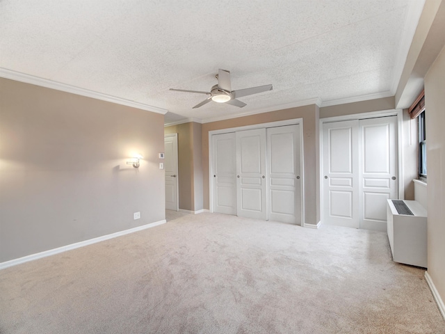 250 Gorge Rd Unit 16D, Cliffside Park, NJ 07010 - unfurnished bedroom with carpet flooring, two closets, crown molding, a textured ceiling, and a ceiling fan