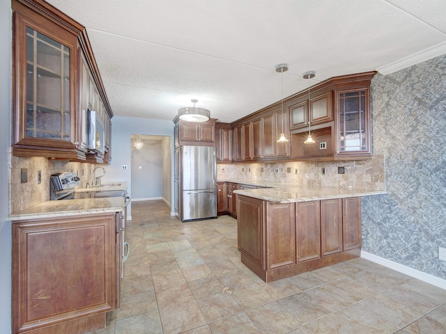 250 Gorge Rd Unit 16D, Cliffside Park, NJ 07010 - kitchen featuring stainless steel appliances, a peninsula, light stone counters, tasteful backsplash, and a textured ceiling