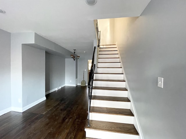 stairway with baseboards and wood finished floors