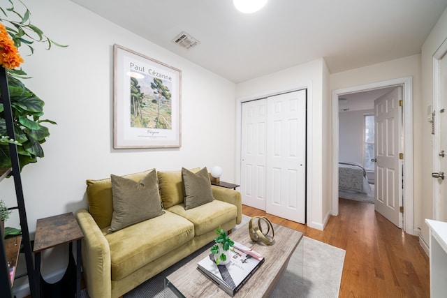 living area with visible vents, baseboards, and light wood-style floors