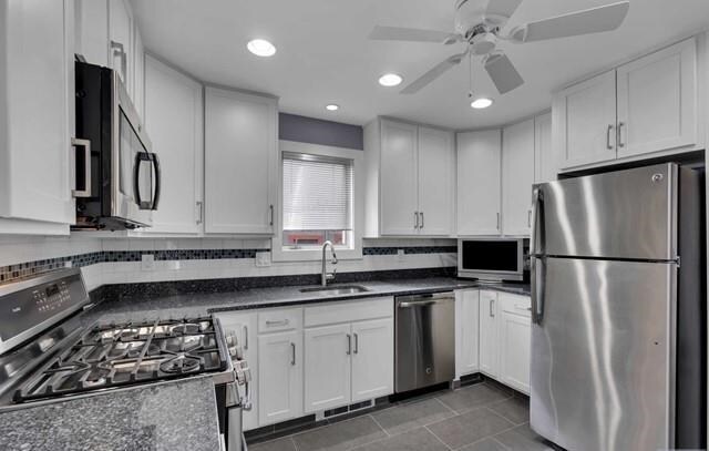 592 Forest St, Kearny, NJ 07032 - kitchen featuring stainless steel appliances, dark countertops, white cabinetry, recessed lighting, and a ceiling fan