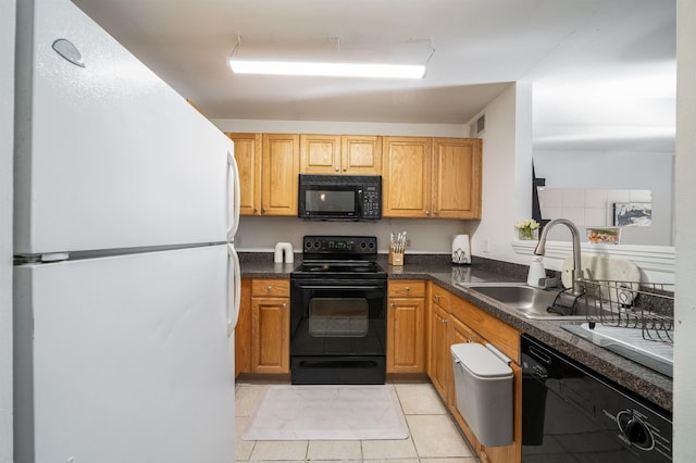 kitchen with sink, light tile patterned floors, and black appliances