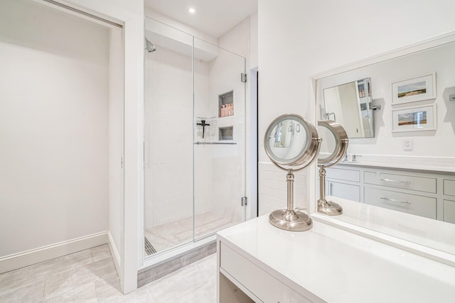 bathroom featuring vanity, a stall shower, and recessed lighting