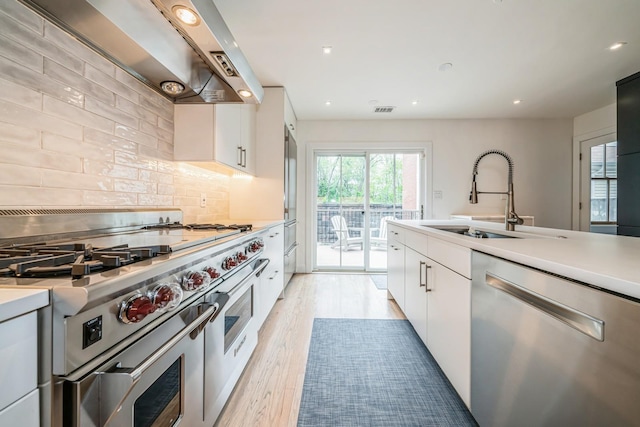 kitchen featuring plenty of natural light, a sink, light countertops, and stainless steel appliances