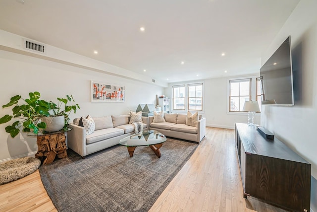 living area with recessed lighting, baseboards, visible vents, and light wood-type flooring