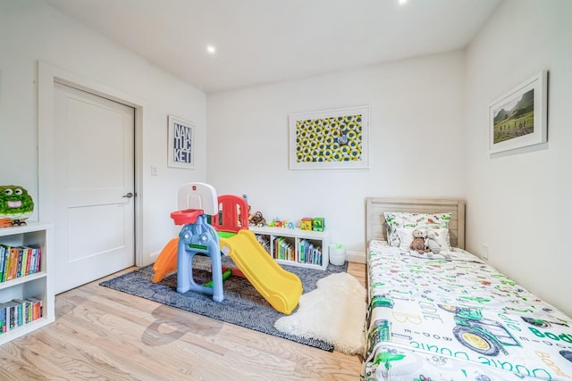 bedroom featuring recessed lighting and wood finished floors