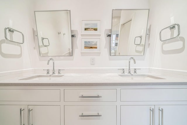 bathroom with double vanity and a sink