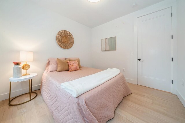 22 Bright St Unit 1, Jersey City, NJ 07302 - bedroom with light wood-style floors and baseboards