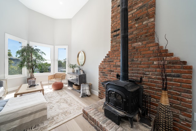 living room featuring light hardwood / wood-style floors and a wood stove