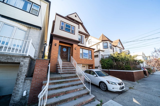 20 W 22nd St, Bayonne, NJ 07002 - multi unit property featuring a garage, brick siding, driveway, and a residential view