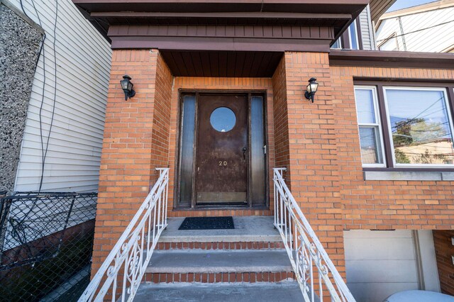 20 W 22nd St, Bayonne, NJ 07002 - property entrance featuring brick siding and an attached garage