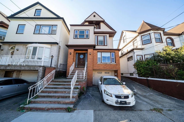 20 W 22nd St, Bayonne, NJ 07002 - view of property with a garage, driveway, and brick siding