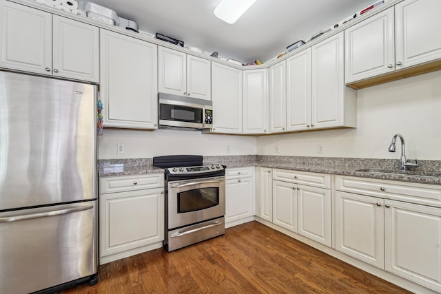 20 Avenue At Port Imperial Unit 113, West New York, NJ 07093 - kitchen with stainless steel appliances, a sink, dark wood finished floors, white cabinets, and stone countertops