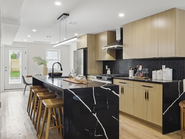 63 Jefferson Ave Unit 1, Jersey City, NJ 07307 - kitchen featuring wall chimney range hood, freestanding refrigerator, modern cabinets, light brown cabinetry, and recessed lighting