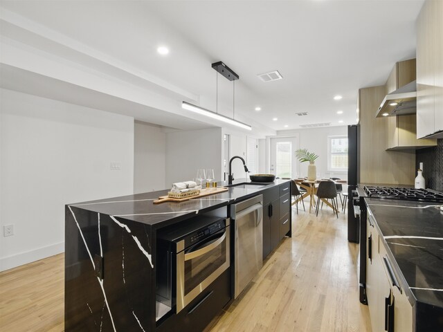 63 Jefferson Ave Unit 1, Jersey City, NJ 07307 - kitchen featuring stainless steel appliances, an island with sink, modern cabinets, range hood, and recessed lighting