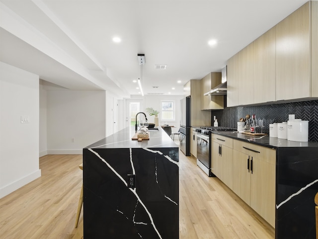 63 Jefferson Ave Unit 1, Jersey City, NJ 07307 - kitchen featuring stainless steel range with gas cooktop, modern cabinets, wall chimney range hood, and recessed lighting