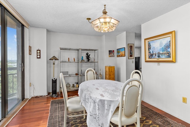 401 Harmon Cv, Secaucus, NJ 07094 - dining room featuring plenty of natural light, wood finished floors, a textured ceiling, and a chandelier