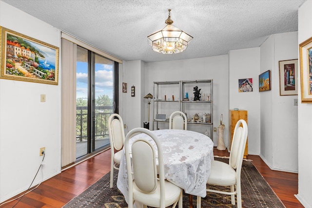 401 Harmon Cv, Secaucus, NJ 07094 - dining space with a chandelier, dark wood finished floors, a wall of windows, and a textured ceiling