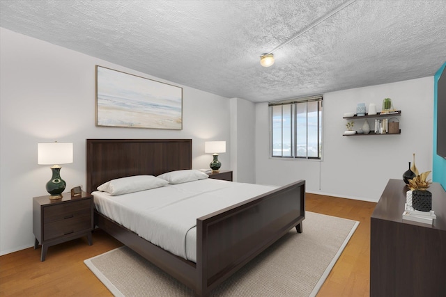 401 Harmon Cv, Secaucus, NJ 07094 - bedroom featuring a textured ceiling and light wood-style flooring