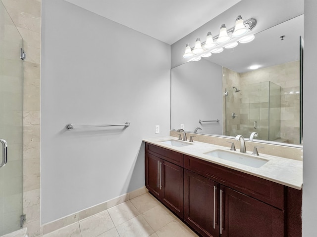 bathroom featuring an enclosed shower, vanity, and tile patterned floors