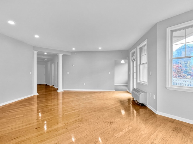 unfurnished living room with light hardwood / wood-style floors and plenty of natural light