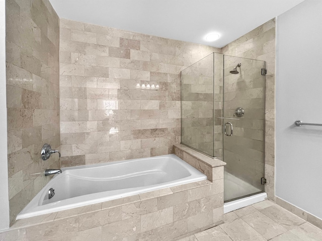 bathroom with separate shower and tub