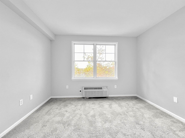 carpeted empty room featuring a wall unit AC