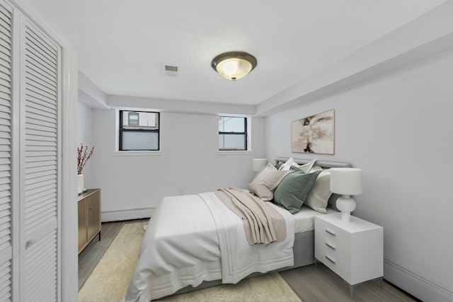 1228 Park Ave Unit B, Hoboken, NJ 07030 - bedroom with a baseboard heating unit, wood finished floors, and a closet