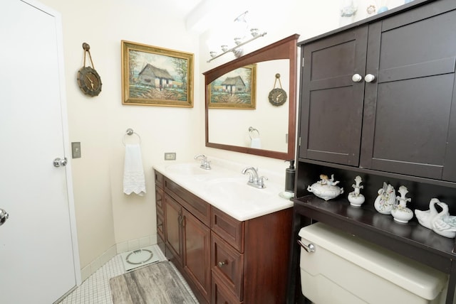 bathroom featuring vanity, tile patterned floors, and toilet