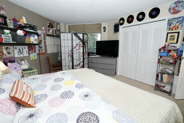 carpeted bedroom featuring a closet and a textured ceiling