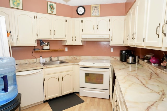 kitchen featuring sink, white cabinets, and white appliances