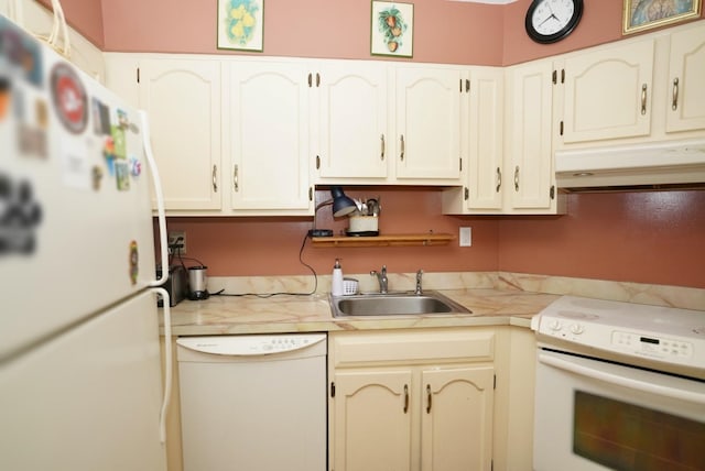 kitchen featuring sink, white appliances, and white cabinets