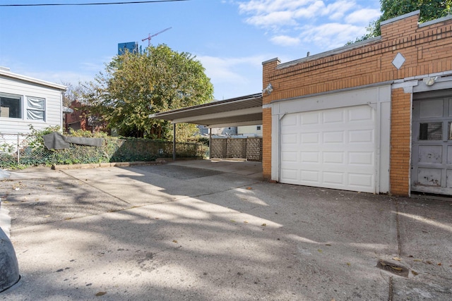 2746 John F Kennedy Blvd, Jersey City, NJ 07306 - garage with an attached carport, driveway, and fence