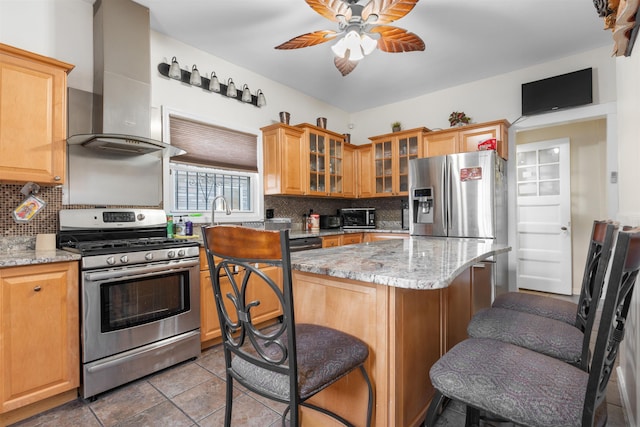 2746 John F Kennedy Blvd, Jersey City, NJ 07306 - kitchen with a kitchen bar, stainless steel appliances, backsplash, wall chimney range hood, and a ceiling fan