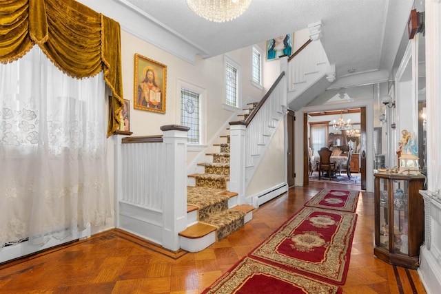 2746 John F Kennedy Blvd, Jersey City, NJ 07306 - entryway featuring stairs, a notable chandelier, baseboard heating, and a textured ceiling
