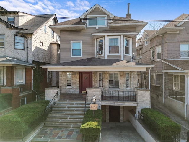 2746 John F Kennedy Blvd, Jersey City, NJ 07306 - view of front of home featuring stone siding, covered porch, and roof with shingles