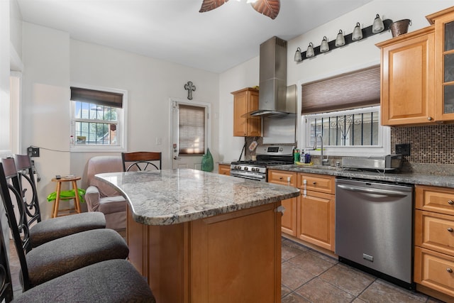 2746 John F Kennedy Blvd, Jersey City, NJ 07306 - kitchen featuring a sink, a breakfast bar, appliances with stainless steel finishes, island exhaust hood, and decorative backsplash