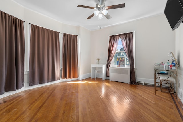 2746 John F Kennedy Blvd, Jersey City, NJ 07306 - unfurnished room featuring radiator heating unit, a ceiling fan, hardwood / wood-style floors, and baseboards