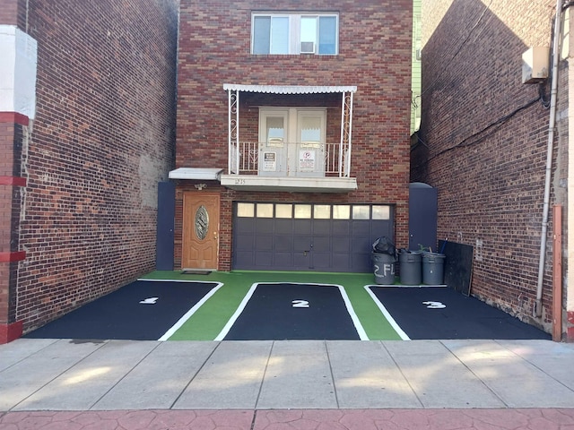 1215 Bergenline Ave, Union City, NJ 07087 - entrance to property with an attached garage, brick siding, and a balcony