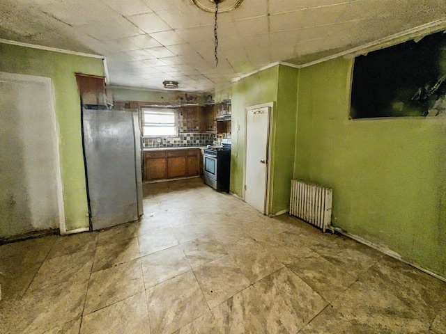 kitchen with crown molding, stainless steel appliances, and radiator