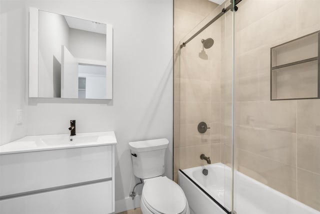 full bathroom with enclosed tub / shower combo, vanity, and toilet